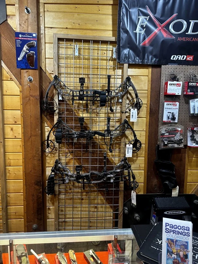 Vertical rack of compound bows at Pagosa Guns & Archery